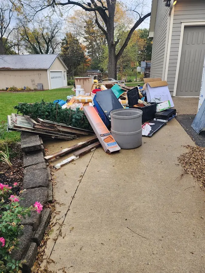 Dumpster being loaded with debris for Estate Cleanout Dumpster Rental in World Golf Village